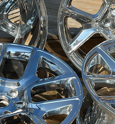 close up photo of four polished OEM wheels