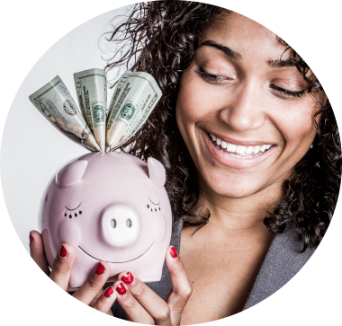 woman smiles while holding a pink piggy bank that has a few twenty dollar bills popping out of the top