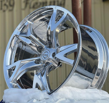 Ceramic polished wheel at Yvonne's Tire Inc shown outside on a stand in winter