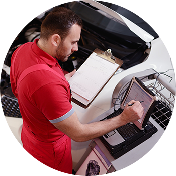 Technician troubleshooting engine trouble light by performing a diagnostic in Wasilla, AK