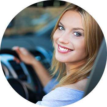 Girl smiling in used car in Spokane, WA